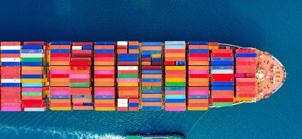 Aerial view of container cargo ship in sea.